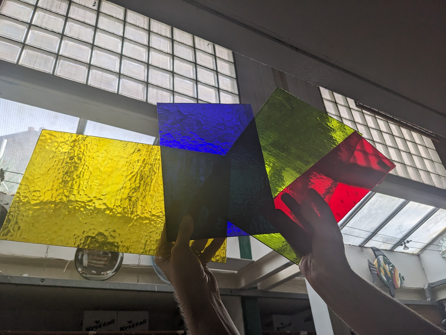 Coloured glass samples held up to daylight.